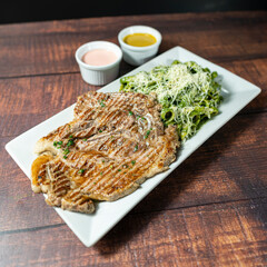 pork chop with green noodles, peruvian food