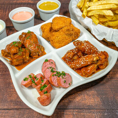 bbq wings with french fries, chicken nugget and fried chorizo sausage