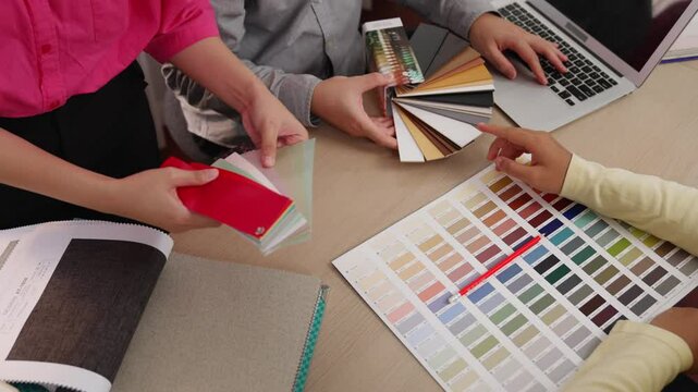 Hand closeup architect and interior designer presenting textile material and color from color palette for interior house design based on customer oversee and supervised. Variegated