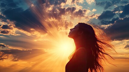 Naklejka premium Woman silhouette at sunset. This photo depicts hope, peace, and serenity, and can be used for inspirational designs.