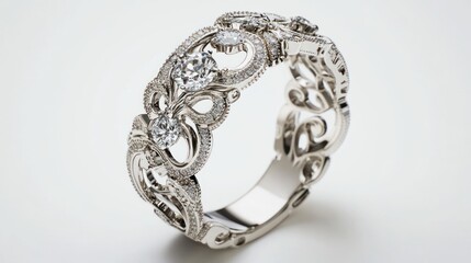 Diamond ring with a pear shaped stone and pave diamonds in ornate silver setting.