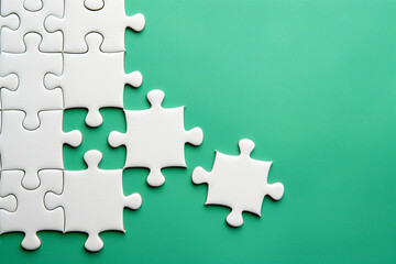 White Puzzle Pieces on Green Background with Missing Parts