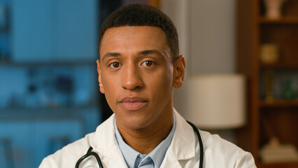 Close up confident doctor therapist African American man medic healthcare pediatrician worker practitioner physician professional specialist ethnic job face employee male looking at camera expression
