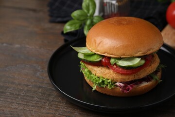 Delicious vegan burger with chickpea cutlet on wooden table, closeup