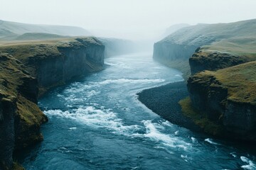 A River Flowing Through a Foggy Canyon in Iceland