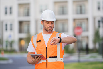 Civil Worker engineer african american man wearing hard hat and smiling. happy positive manager or contractor, heavy machinery. Construction worker on top of a building. builder in working uniform