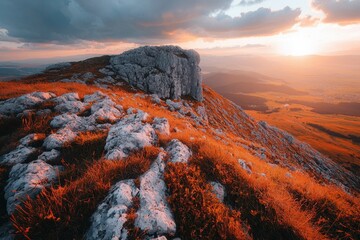 Rocky Mountain Ridge at Sunset with Grass and a Distant Valley