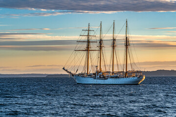 Chilean Navy's instruction sailboat Esmeralda anchored in the bay of Puerto Montt at sunset,...