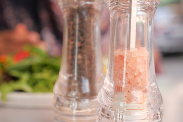 Delightful Salt and Pepper Shakers Accompanied by a Delicious Meal Presented on Table