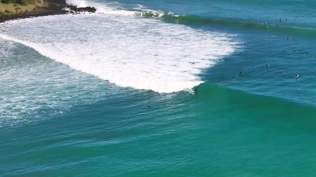 Surfer in a wave at the beach in New Zealand