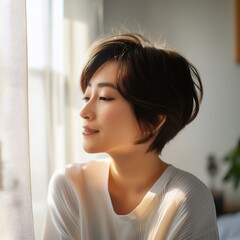 Fototapeta premium A beautiful young Japanese woman with glowing, dewy skin and silky, tousled black hair exudes natural elegance. Her almond eyes sparkle with kindness, and her warm smile radiates grace and serenity.