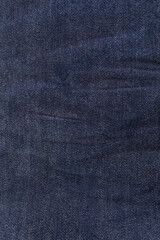 An image of close-up blue denim jeans fabric showing detailed texture with a dark blue color and a stylish design backdrop