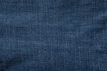 close-up blue denim jeans fabric showing detailed texture with a dark blue color and a stylish...