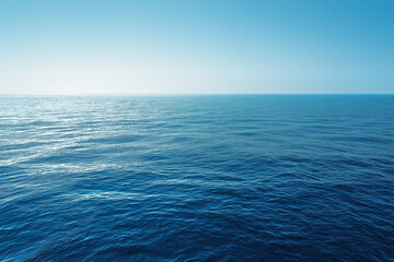 Fototapeta premium Deep blue ocean water surface meeting clear sky horizon