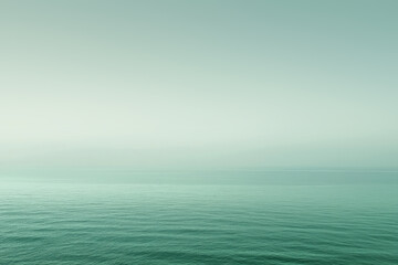 Obraz premium Calm ocean water merging with pastel colors sky creating relaxing background