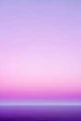 Calm ocean reflecting a purple and pink sunset sky