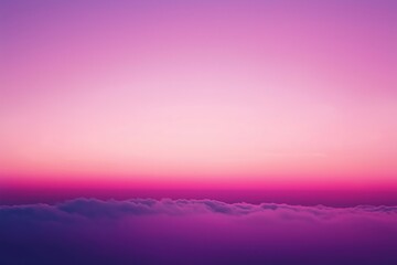 Pink and purple sunset sky transforming into night above the clouds