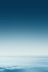 Fototapeta premium Deep blue sky fading into white clouds creating gradient effect