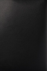 Polished black leather with fine grain forming a sleek and luxurious background.