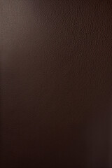 Polished dark brown leather with a smooth surface and fine texture.