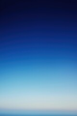 Clear blue sky background fading to white at the horizon