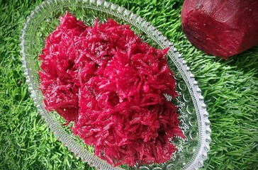 Grated beetroot in bowl.