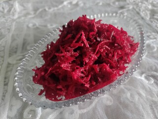 Grated beetroot in bowl.
