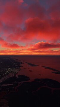 Aerial shot flying over the City of Faro at sunset in Portugal. Landscape of the coast and beaches of Portugal