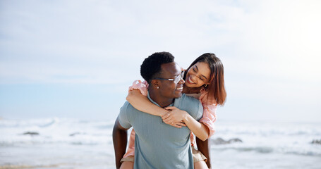 Love, piggyback and happy with interracial couple at beach for travel destination, summer and honeymoon vacation. Relax, tropical and adventure with man and woman for holiday, bonding or romance