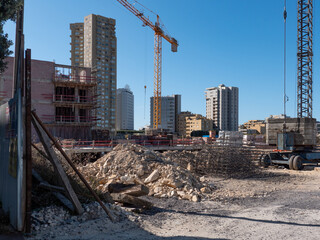 New apartment building under construction. Building site with rubble as the foundations are laid....
