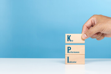 KPI,Key,Performance,Indicators, Operational success, Evaluate progress. A man holding wooden block...