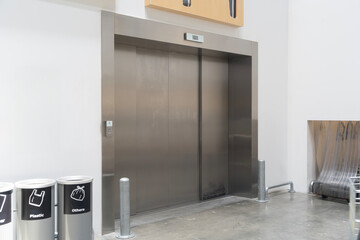 Modern Elevator Entrance with recycling bins in Commercial Building or mall