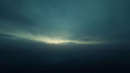 Naklejka premium A dimly lit sky just before dusk, with soft blue and gray tones as the sun sets behind the horizon, casting a gentle twilight glow.