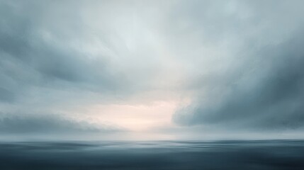 A moody sky just before dusk, with gray and soft pastel shades blending as the daylight fades and a gentle breeze moves the clouds.