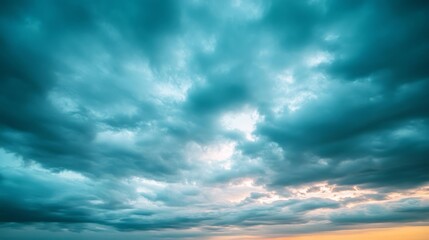 Obraz premium A panoramic view of the sky right before dusk, with cool tones of blue and gray, the horizon softly glowing with remnants of sunlight.