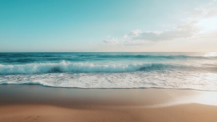Fototapeta premium A serene beach scene with gentle waves lapping against the shore under a blue sky, perfect for relaxation and tranquility.