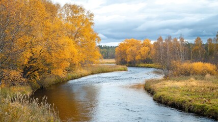 Obraz premium A tranquil river flows through a scenic landscape adorned with vibrant autumn foliage under a cloudy sky.