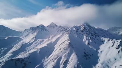 Obraz premium Breathtaking view of snow-capped mountains under a clear blue sky, showcasing the beauty of winter in nature.