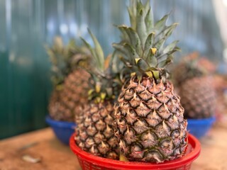 Fototapeta premium Fresh Pineapple Fruits at the fruit market.Famous Traditional fruits of Thailand, Malaysia .Fresh fruit stalls in the local market.