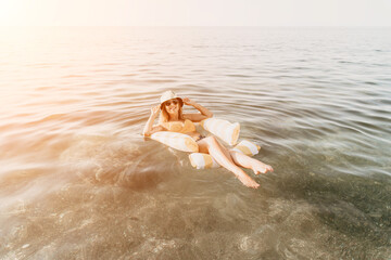 Woman, Inflatable Float, Ocean - Woman relaxing on inflatable float in the ocean.
