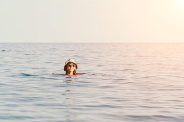 Woman Swimming Ocean Summer - A woman swims in the ocean on a sunny summer day.