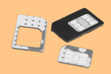 close up of mobile sim card pixelate grayscale color halftone dotted texture style collage element isolated on orange background