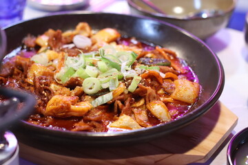 A flavorful dish of spicy stir-fried pork, coated in a rich, vibrant red sauce. The tender pork pieces are seasoned with garlic and chili paste, creating a bold and savory taste.

