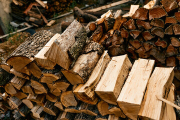 Stacked firewood in front of rustic cabin