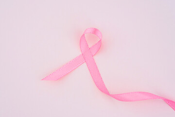 Pink ribbon symbolizing breast cancer awareness on a soft background