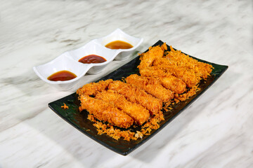 fried ham served with three flavorful dipping sauces. The golden-brown ham pairs perfectly with the variety of sauces, offering a mix of textures and tastes.