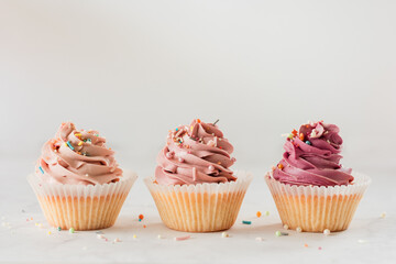 Front view of three pretty pink cupcakes