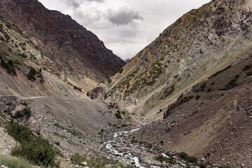 Dirt road to the Deosai Natural Park between mountains