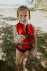 Child in Life Vest Enjoying Summer Outdoors at Bluestem Camping Trip