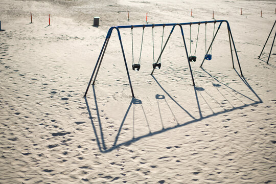 Swing set in the sand on a Southern California beach not being u